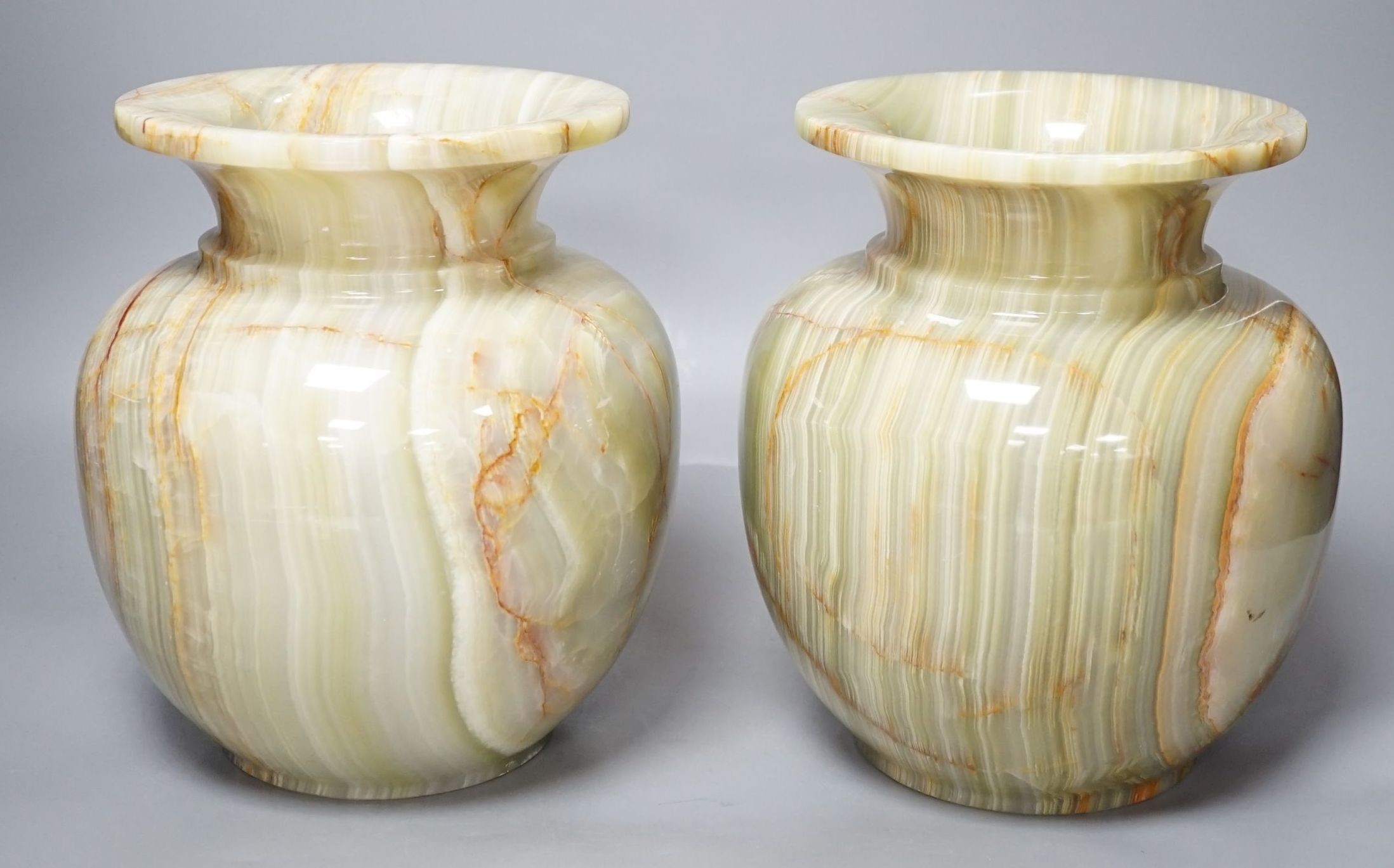 A pair of green onyx vases, 23 cms high.